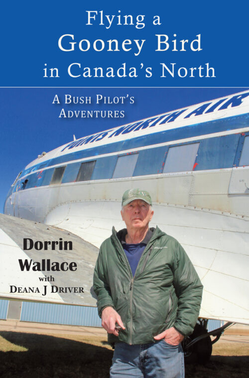 A man standing in front of a large DC-3 airplane.